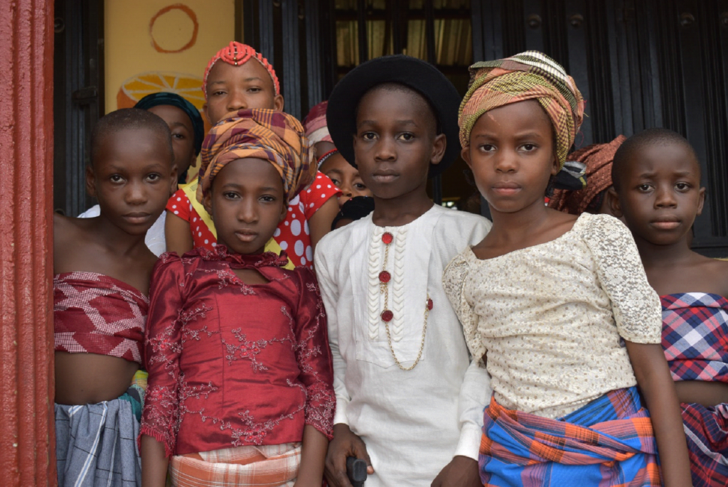Children from school in Bane in traditional dress after performing at welcoming ceremony, November 2019