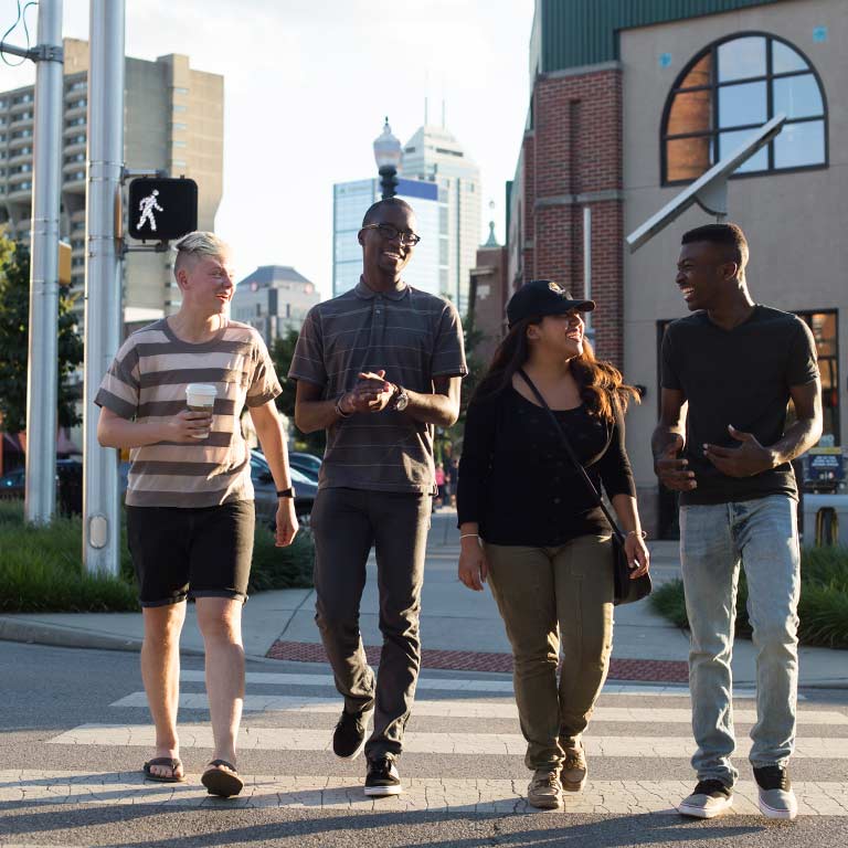 Four students cross the street in Indianapolis.