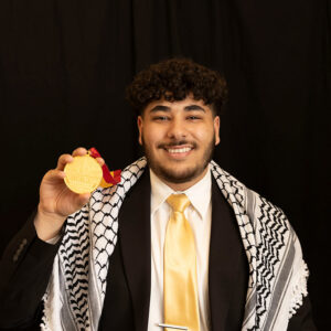 Yaqoub Saadeh displays his Plater Medallion for civic engagement