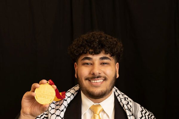 Yaqoub Saadeh displays his Plater Medallion for civic engagement