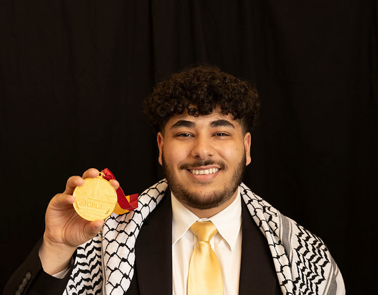 Yaqoub Saadeh displays his Plater Medallion for civic engagement