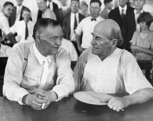 Clarence Darrow (left), a famous Chicago lawyer, informs William Jennings Bryan (right), defender of Fundamentalism, that he’s got $50 riding on the monkey.