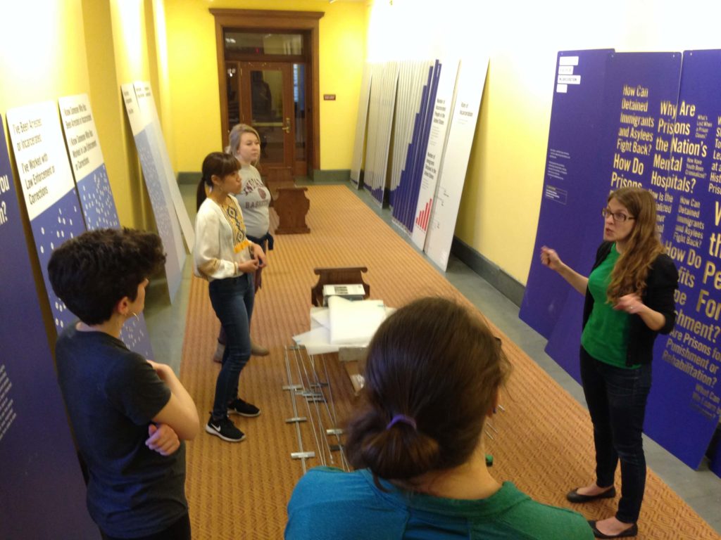 Dr. Laura Holzman and students install an exhibit at the Central Library in downtown Indianapolis.