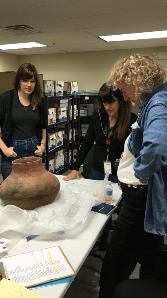 Dr. Holly Cusack-McVeigh and a student care for objects with the FBI Art Crime Team.