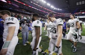 Michigan State players leave the field after the Cotton Bowl loss to Alabama on Dec. 31, in Arlington, Texas. Alabama won 38-0 to advance to the championship game. (AP Photo | Tony Gutierrez)