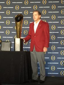 Alabama head coach Nick Saban poses with the College Football Playoff National Championship trophy on Jan. 12, the day after winning his fifth overall title and fourth in seven seasons at Alabama. (Photo by Malcolm Moran)