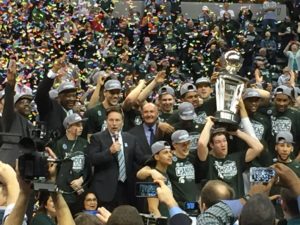 Michigan State coach Tom Izzo addresses Spartans fans while the players hoist the Big Ten tournament championship trophy on March 13 at Bankers Life Fieldhouse in Indianapolis.