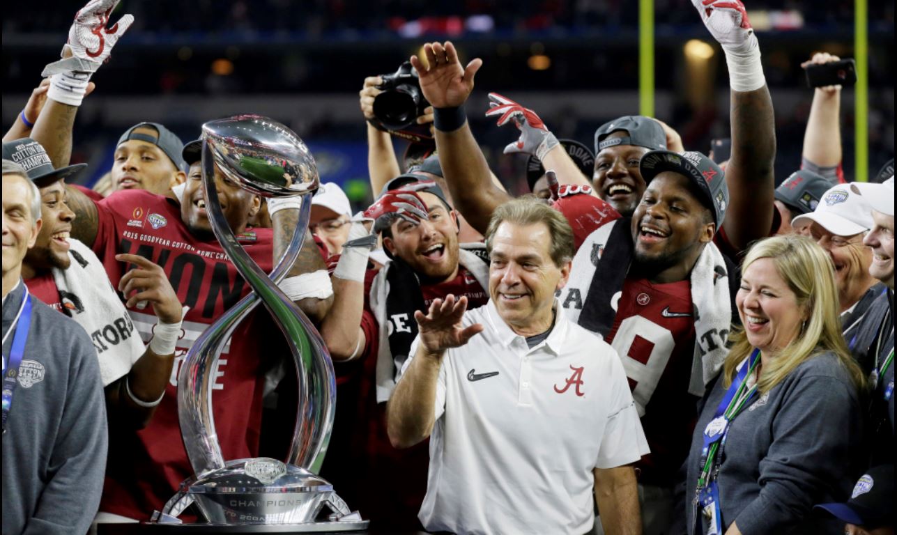 Alabama head coach Nick Saban and players are presented with the Cotton Bowl trophy following their 38-0 win over Michigan State. (AP photo)